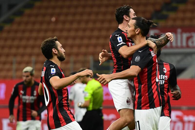 Zlatan Ibrahimovic celebrates with teammates after scoring AC Milan's second goal. AFP