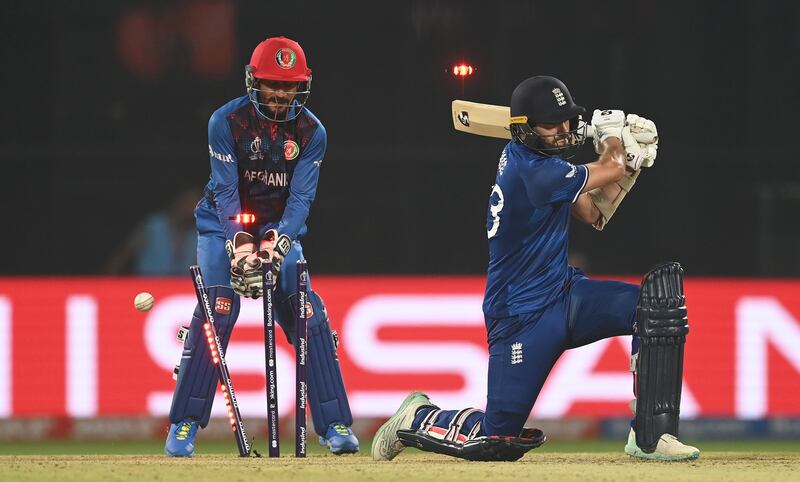 Mark Wood of England is bowled by Rashid Khan as Afghanistan completed a stunning victory in their World Cup match at the Arun Jaitley Stadium in Delhi on Sunday, October 15, 2023. Getty