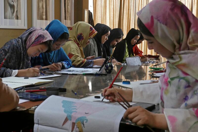 Afghan girls paint at a workshop class in Herat. The World Bank estimates that for each year of secondary education, the likelihood of marrying before the age of 18 decreases by five percentage points or more. AFP