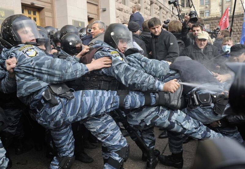 Activists of Ukrainian opposition parties clash with riot police as they attempt to get into the mayoral office during a rally against the Kiev mayoral election. Maks Levin / EPA