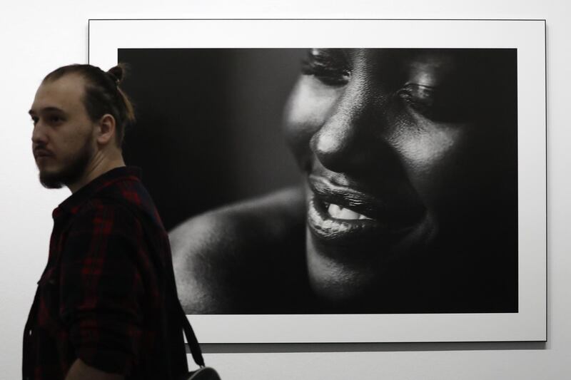 MOSCOW, RUSSIA - MARCH 16, 2017: A man walks past a photograph of actress Lupita Nyong'o taken for the 2017 Pirelli Calendar on display at an exhibition titled "Pirelli Calendar 2017 by Peter Lindbergh" at Moscow's Multimedia Art Museum. The exhibition is open from March 17 to May 14, 2017. Artyom Geodakyan/TASS (Photo by Artyom Geodakyan\TASS via Getty Images)