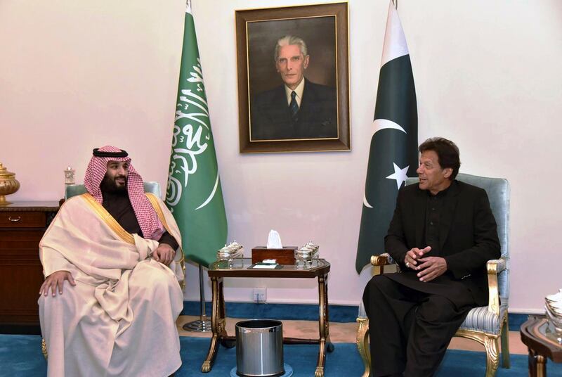 In this photo released by the Press Information Department, visiting Saudi Arabia's Crown Prince Mohammed bin Salman, left, listens to Pakistani Prime Minister Imran Khan during a meeting in Islamabad, Pakistan, Sunday, Feb. 17, 2019.  Saudi Arabia's powerful Crown Prince Mohammed bin Salman began his four-day regional visit on Sunday, arriving in Pakistan where he is expected to sign agreements worth billions of dollars to help the Islamic nation overcome its financial crisis. (Press Information Department, via AP)