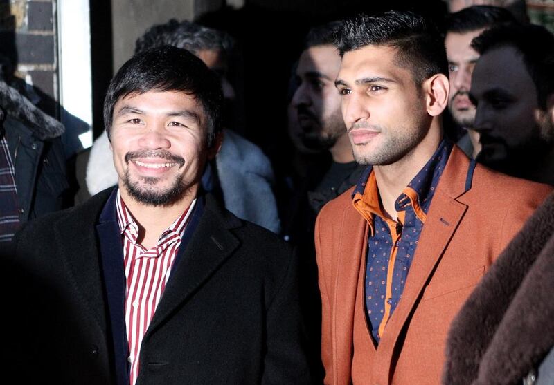 A fight between Manny Pacquiao, left, and Amir Khan, right, in the UAE is edging closer to being confirmed. Martin Willetts / Getty Images 