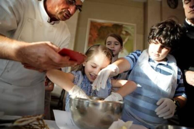 October 26, 2011 (Abu Dhabi) Alain Blanchard, from the Lenotre culinary school in Paris shows children how to make cookies at the Shangri-La Hotel in Abu Dhabi October 26, 2011.  (Sammy Dallal / The National)