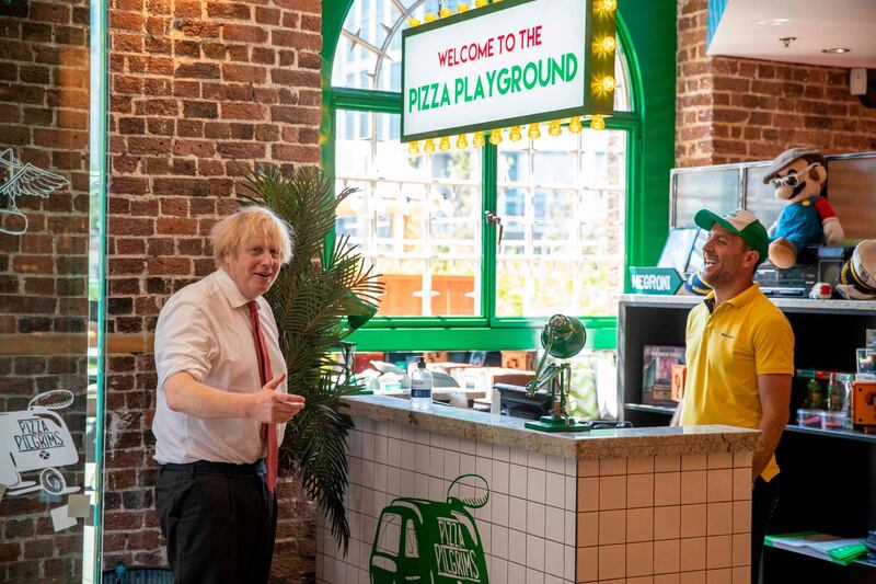 Britain's Prime Minister Boris Johnson visits Pizza Pilgrims in West India Quay, London Docklands, as the restaurant prepares to reopen on July 4. AFP