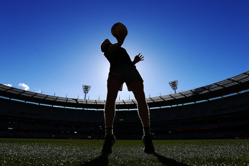 A boundary umpire throws the ball in in his warm up during the round 20 AFL match between the Melbourne Demons and the Gold Coast Suns at Melbourne Cricket Ground in Melbourne, Australia. Michael Dodge/Getty Images