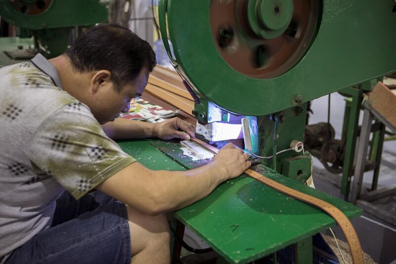 An employee manufactures leather belts at the Guangzhou Jinhuamei Leatherware Co. factory in Guangzhou, China, on Wednesday, Sept. 5, 2018. As the trade war between the U.S. and China disrupts the supply of goods and materials across the Pacific Ocean, a vast web of suppliers, distributors, manufacturers and customers that took decades to build is being challenged by tariffs on both shores. Photographer: Giulia Marchi/Bloomberg