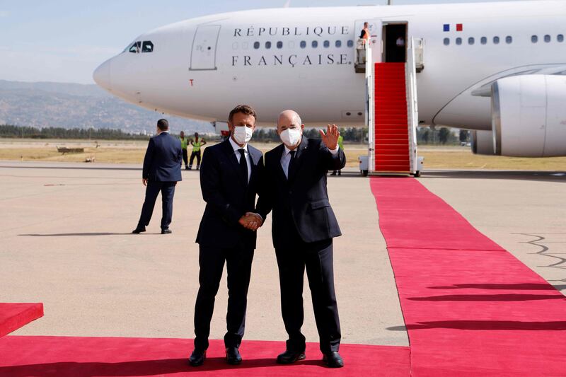 French President Emmanuel Macron is welcomed by Algeria's President Abdelmadjid Tebboune in Algiers. AFP