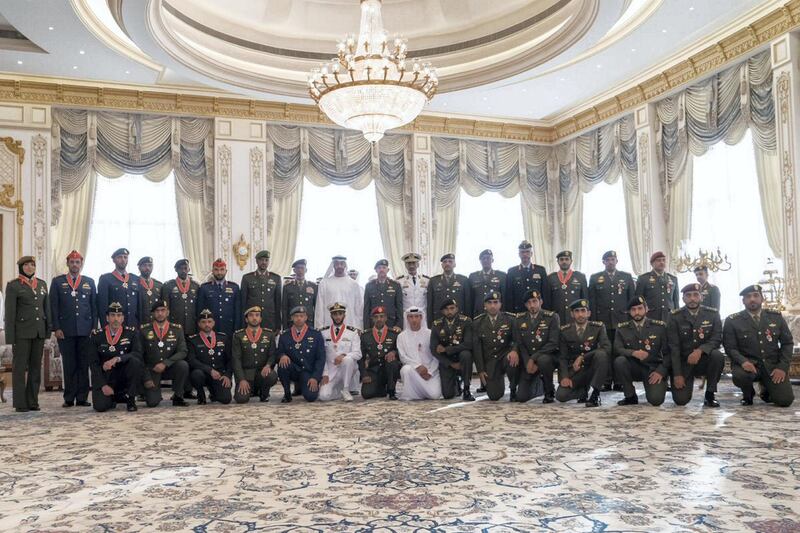 Sheikh Mohamed bin Zayed stands for a group photo with the members of the UAE Armed Forces who he honoured for their humanitarian work during a ceremony at Qasr Al Bahr Majlis on Monday. Courtesy Sheikh Mohamed bin Zayed Twitter