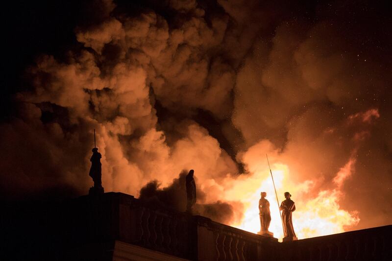 FILE - In this Sept. 2, 2018 file photo, flames engulf the 200-year-old National Museum of Brazil, in Rio de Janeiro. Federal police say an air conditioning unit is the â€œprimary causeâ€ of the fire that destroyed Brazilâ€™s National Museum in Rio de Janeiro. Fire experts have presented the conclusions of a seven-month investigation into the Sept. 2, 2018 fire, which began in the museumâ€™s auditorium and quickly spread to the rest of the building, destroying most of its 20 million artifacts. (AP Photo/Leo Correa, File)