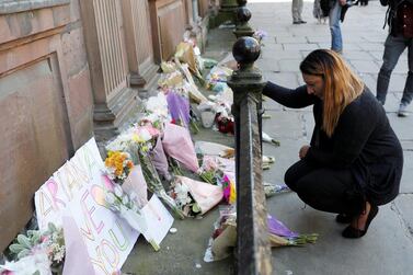 A woman lays flowers for the victims of the Manchester Arena attack. REUTERS/Darren Staples