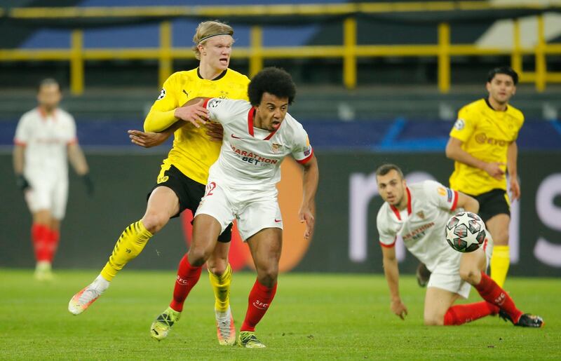 Borussia Dortmund's Erling Braut Haaland in action with Sevilla's Jules Kounde. Reuters