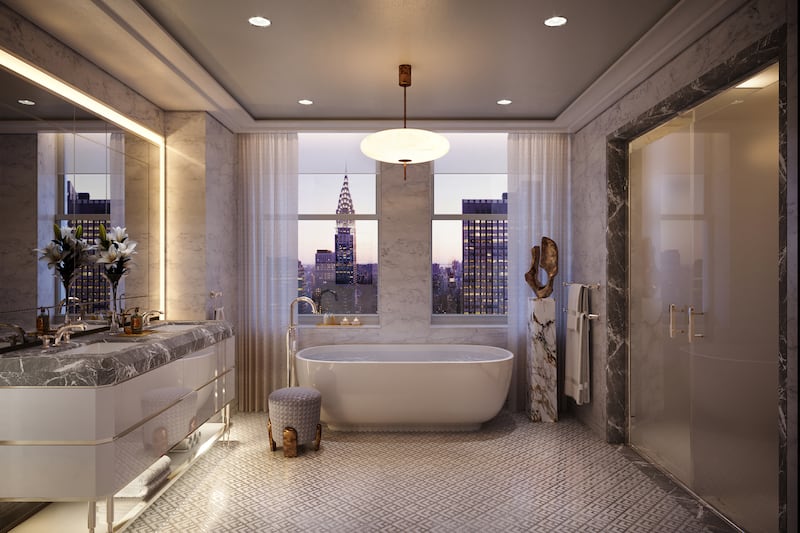 A primary bathroom, offering views of the Manhattan skyline.