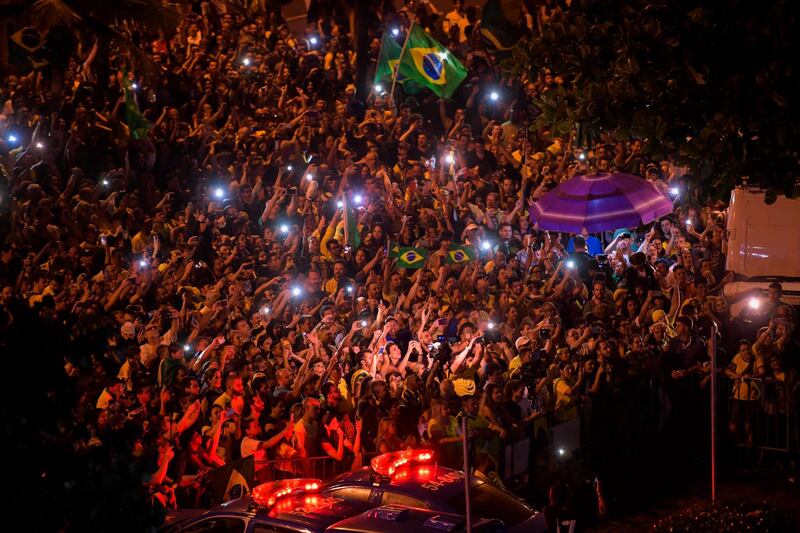 Supporters of Jair Bolsonaro celebrate in front of his house in Rio de Janeiro. AFP