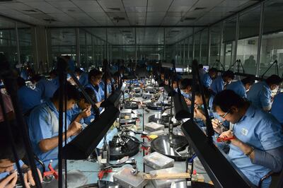 Workers cut and polish diamonds on a production line at a processing centre in Surat. AFP