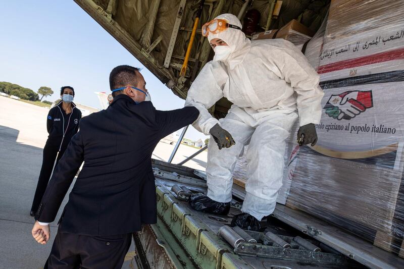 Airport staff unload medical aid sent to Italy from Egypt near Rome. EPA