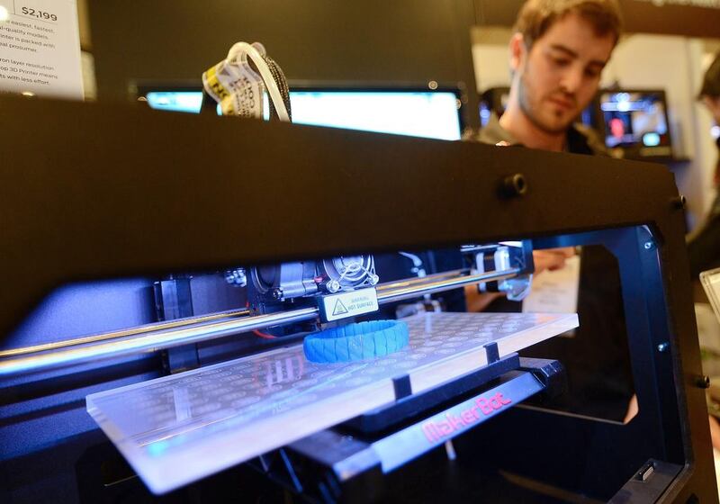 Visitors look at a 3D printer printing an object, during "Inside 3D Printing" conference and exhibition in New York. There are only a handful of 3D printer suppliers in the rMiddle East.  AFP PHOTO/Emmanuel Dunand