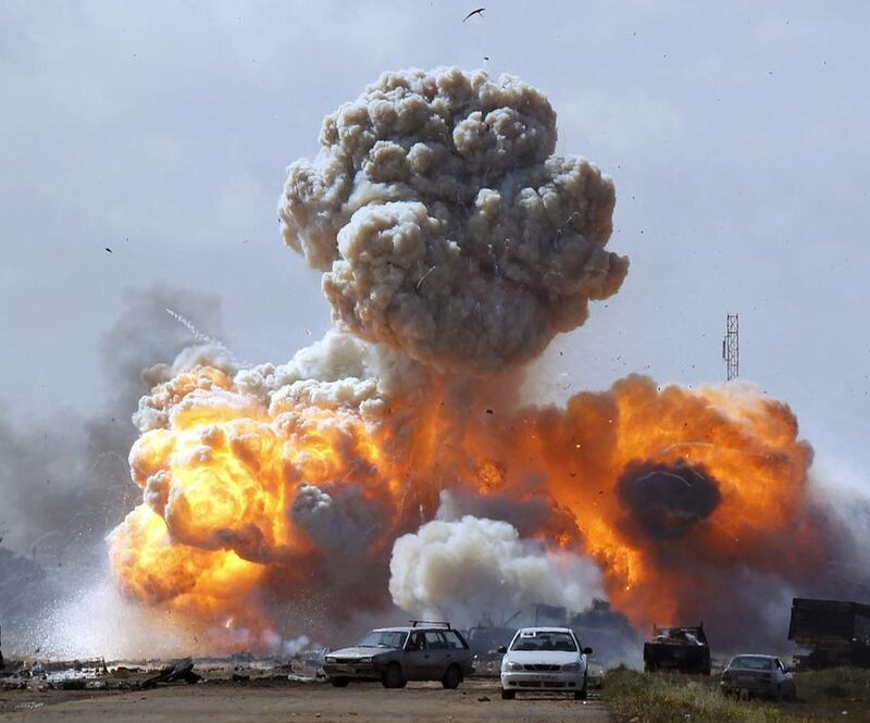 Vehicles belonging to forces loyal to Libyan leader Muammar Gaddafi are hit by a coalition air strike in 2011. Goran Tomasevic / Reuters

