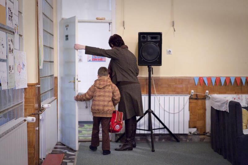 A preschooler is escorted to his classroom by a teacher at the Donje Rosulje Kindergarten School In Visoko, Bosnia and Herzegovina. Razan Alzayani / The National 