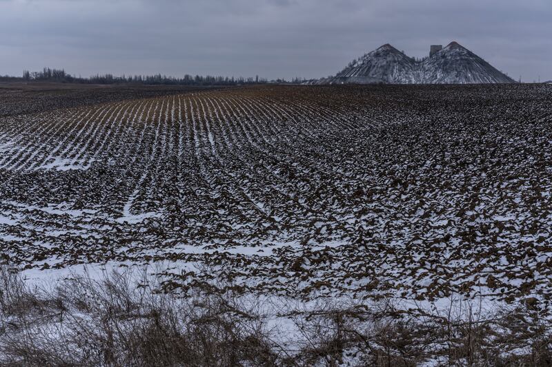 Slag heaps from a coal mine stand on the horizon near the village of Toretsk, Ukraine, in January. Getty Images