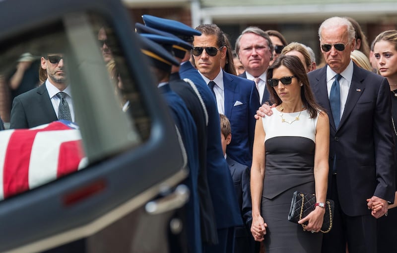 U.S. Vice President Joe Biden (R) stands with his son's brother Hunter (C) and widow Hallie (2nd R) as his son's casket is taken from a hearse before a funeral mass for former Delaware Attorney General Beau Biden, son of Vice President Biden, at St. Anthony of Padua Church in Wilmington, Delaware June 6, 2015.  REUTERS/Bryan Woolston