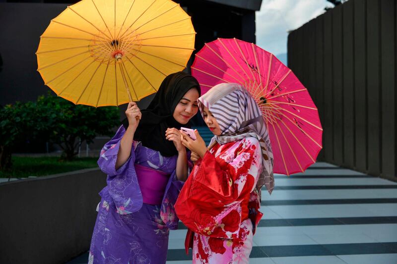 Indonesian students dressed in kimonos take part in an event to mark the eighth anniversary of the 2011 tsunami disasterin Japan, at the Aceh Tsunami Museum in Banda Aceh. AFP