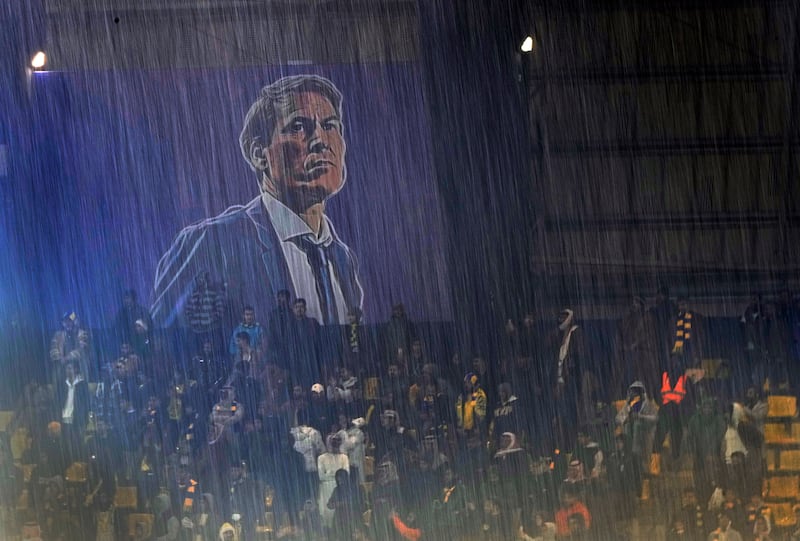 Al Nassr fans sit during heavy rain at Mrsool Park in Riyadh. AP