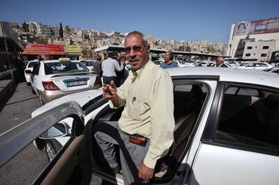 Public taxi driver Abdel-Wali al-Shwara waits at his taxi for his turn to come to take passengers at the Raghadan taxi station in Amman, Jordan on February 11, 2010. (Salah Malkawi for The National)