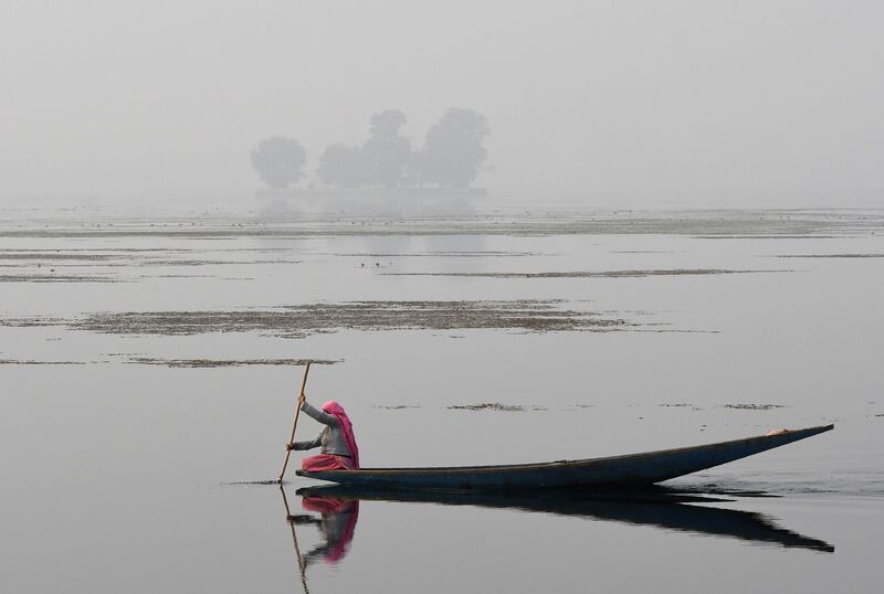 A Kashmiri rows a boat across Dal Lake in Srinagar. Tauseef Mustafa / AFP Photo