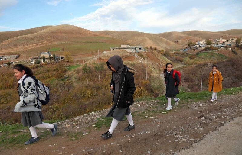 Youngsters walk to school in Sharboty Saghira. AFP