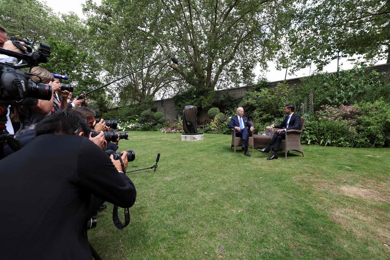Members of the press crowd together to snap the world leaders. AFP