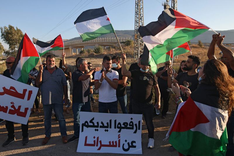 Palestinians outside Israel's Gilboa prison. The last two escapees were recaptured on Sunday. Israeli police named them as Munadel Infeiat and Ayham Kamamji and said they had been hiding out at a house.