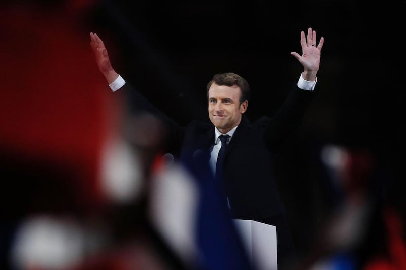 French president-elect Emmanuel Macron waves to the crowd as he delivers a speech at the Pyramid at the Louvre Museum in Paris. Patrick Kovarik / AFP