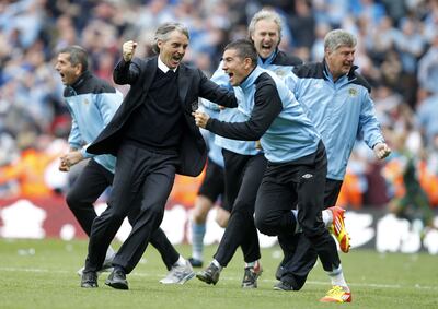 Manchester City manager Roberto Mancini reacts as his team win the Premier League. PA