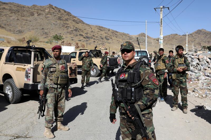 Afghan special forces stand guard at the site of a suicide car bomb explosion that killed at least four people, on outskirts of Kabul, Afghanistan, Thursday, Sept. 12, 2019. Taliban spokesman Zabihullah Mujahid has claimed responsibility for the bombing in a statement sent to the media. (AP Photo/Ebrahim Noroozi)