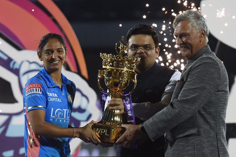 Mumbai Indians captain Harmanpreet Kaur receives the WPL trophy from BCCI president Roger Binny, right, and secretary Jay Shah at the Brabourne Stadium in Mumbai. AFP