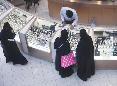 Female shoppers wearing traditional Saudi Arabian dress browse watches on sale at a luxury concession stand inside the Kingdom Centre shopping mall in Riyadh, Saudi Arabia, on Friday, Dec. 2, 2016. Saudi Arabia is working to reduce the Middle East’s biggest economy’s reliance on oil, which provides three-quarters of government revenue, as part of a plan for the biggest economic shakeup since the country’s founding. Photographer: Simon Dawson/Bloomberg