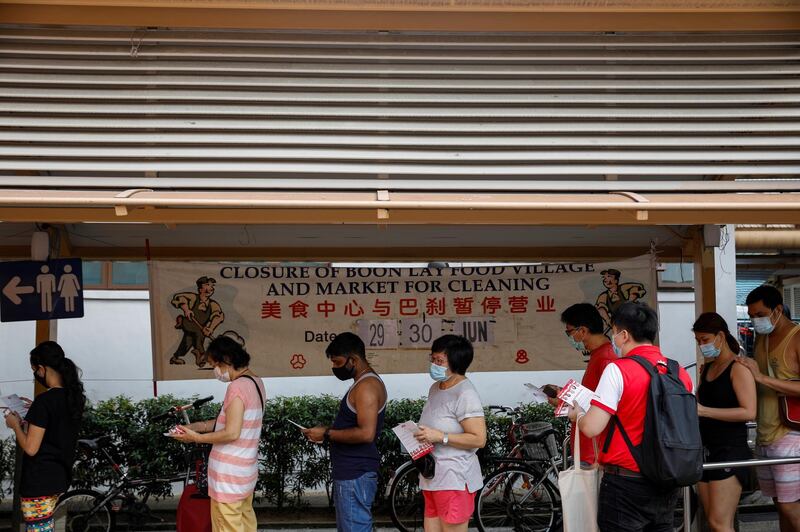 A PSP volunteer hands out leaflets at a food centre ahead of the general election in Singapore on Sunday. Reuters