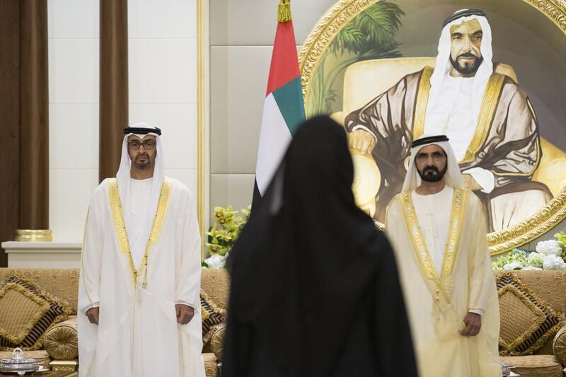 Sheikh Mohammed bin Zayed, Crown Prince of Abu Dhabi and Deputy Supreme Commander of the Armed Forces, and Sheikh Mohammed bin Rashid, Vice-President and Ruler of Dubai, listen as a minister gives her oath, during a swearing-in ceremony for the Cabinet ministers.
