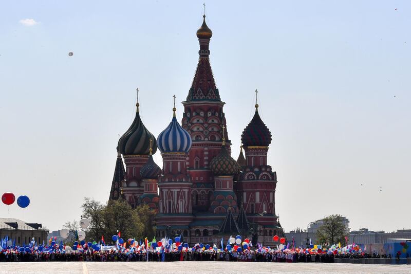 Russian Trade Unions' members holding balloons, flags and artificial flowers line up on Red Square for their May Day demonstration in Moscow on May 1, 2019.  AFP