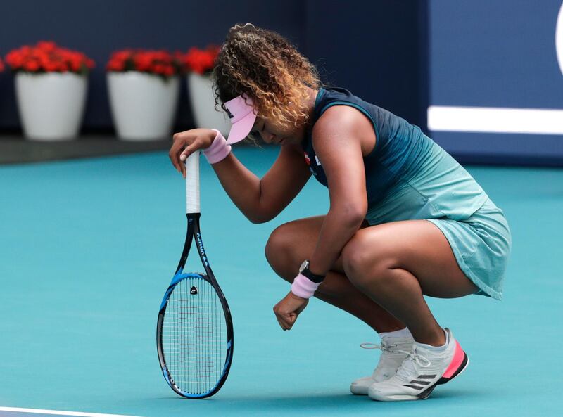 Naomi Osaka, of Japan, kneels on the court during her match against Hsieh Su-Wei, of Taiwan, during the Miami Open tennis tournament, Saturday, March 23, 2019, in Miami Gardens, Fla. (AP Photo/Lynne Sladky)