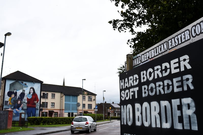 A car drives past a sign saying 'No Border, Hard border, soft border, no border' in Londonderry, Northern Ireland August 16, 2017. REUTERS/Clodagh Kilcoyne