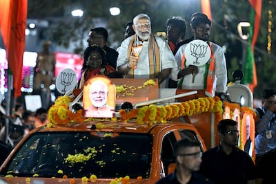 Narendra Modi, India's Prime Minister and leader of the ruling Bharatiya Janata Party, centre, holds the party symbol during a road show at an election campaign in Chennai on April 9. AFP