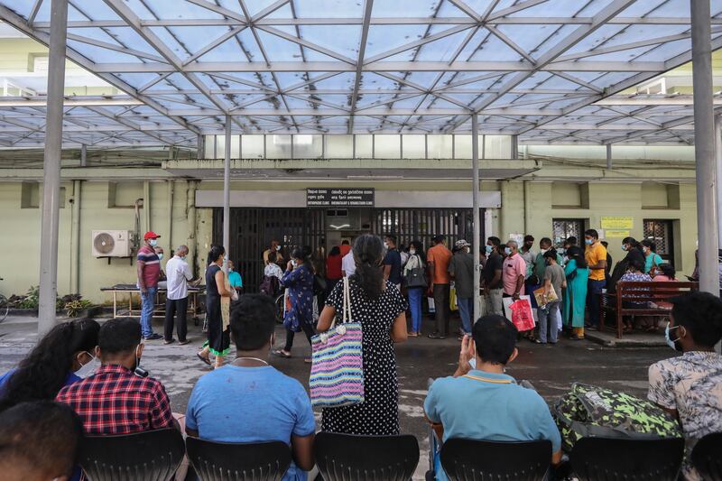 People queue to get medicine from the outpatient department during strike action at the National hospital in Colombo. EPA