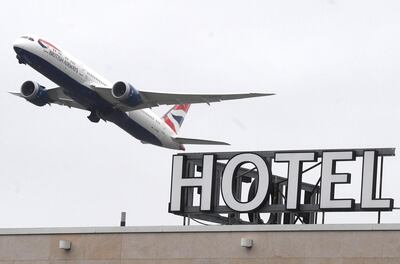 epa08966494 A plane flies over a hotel near Heathrow Airport near London, Britain, 26 January 2021. The British government is expected to approve a plan to require UK citizens to quarantine in a hotel if they arrive in England from high-risk countries.  EPA/NEIL HALL