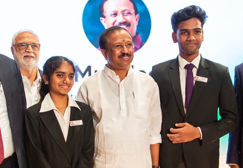 Mr Muraleedharan flanked by India High School pupils  students Gayathri Gopinath, left, and Parthiv Jayachandran  