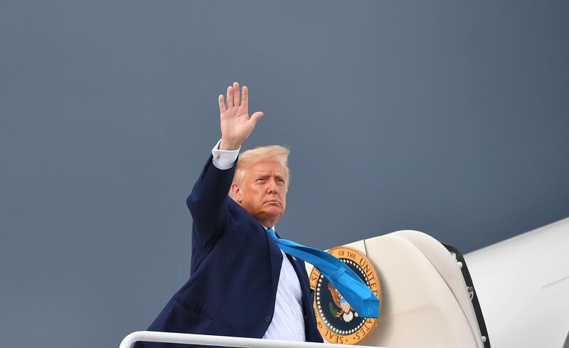 TOPSHOT - US President Donald Trump makes his way to board Air Force One before departing from Andrews Air Force Base in Maryland on September 3, 2020, heading to Latrobe, Pennsylvania for a campaign stop. US President Donald Trump on September 3, 2020 renewed his call for supporters to try to vote twice on November 3, a potentially illegal act that he claimed is the only way to be sure that a ballot is counted. / AFP / MANDEL NGAN
