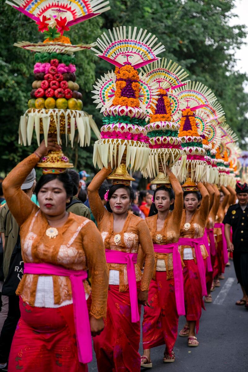 Balinese take part in a parade to mark the opening of the annual Bali Art Festival on a main road in Denpasar, Bali, Indonesia. Made Nagi / EPA