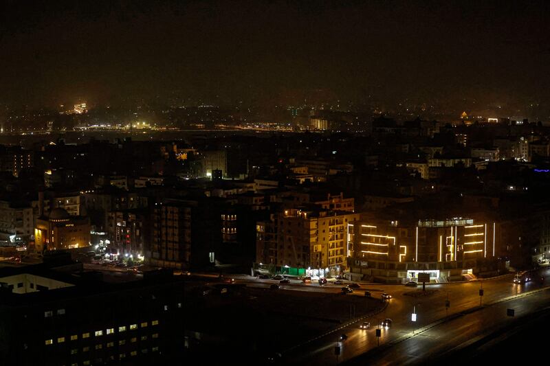 The lights go out over the Moqattam district of Cairo as another power cut hits the capital. AFP
