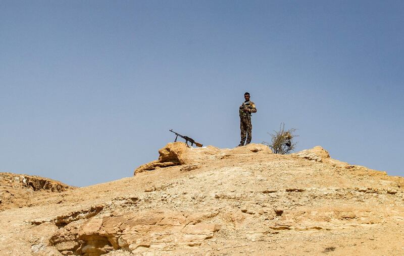 A fighter with the Kurdish-led Syrian Democratic Forces stands guard on a hilltop overlooking the Syria village of Baghouz, where two years ago ISIS made its last stand and was defeated. AFP